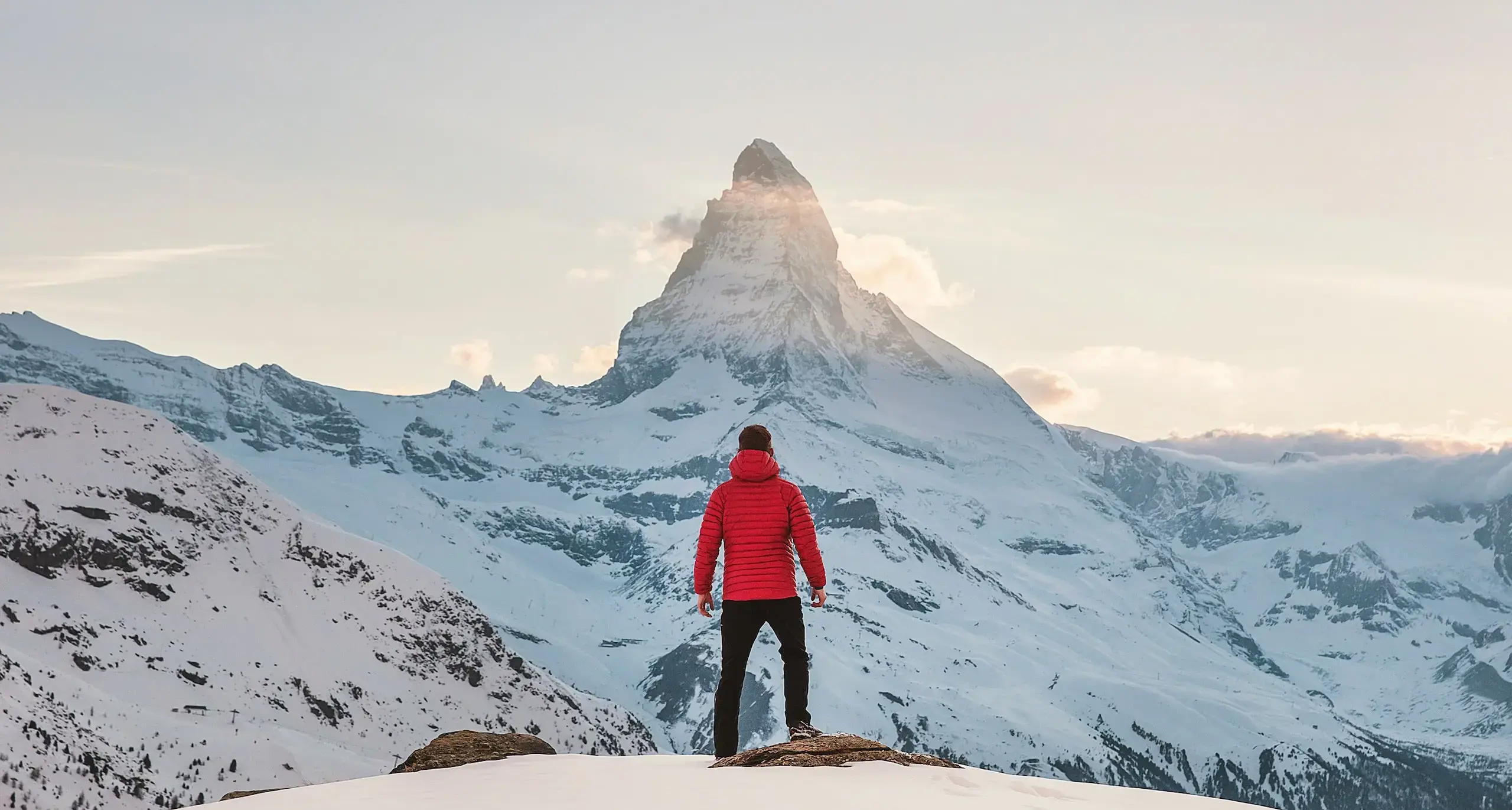 Person standing atop of a mountain