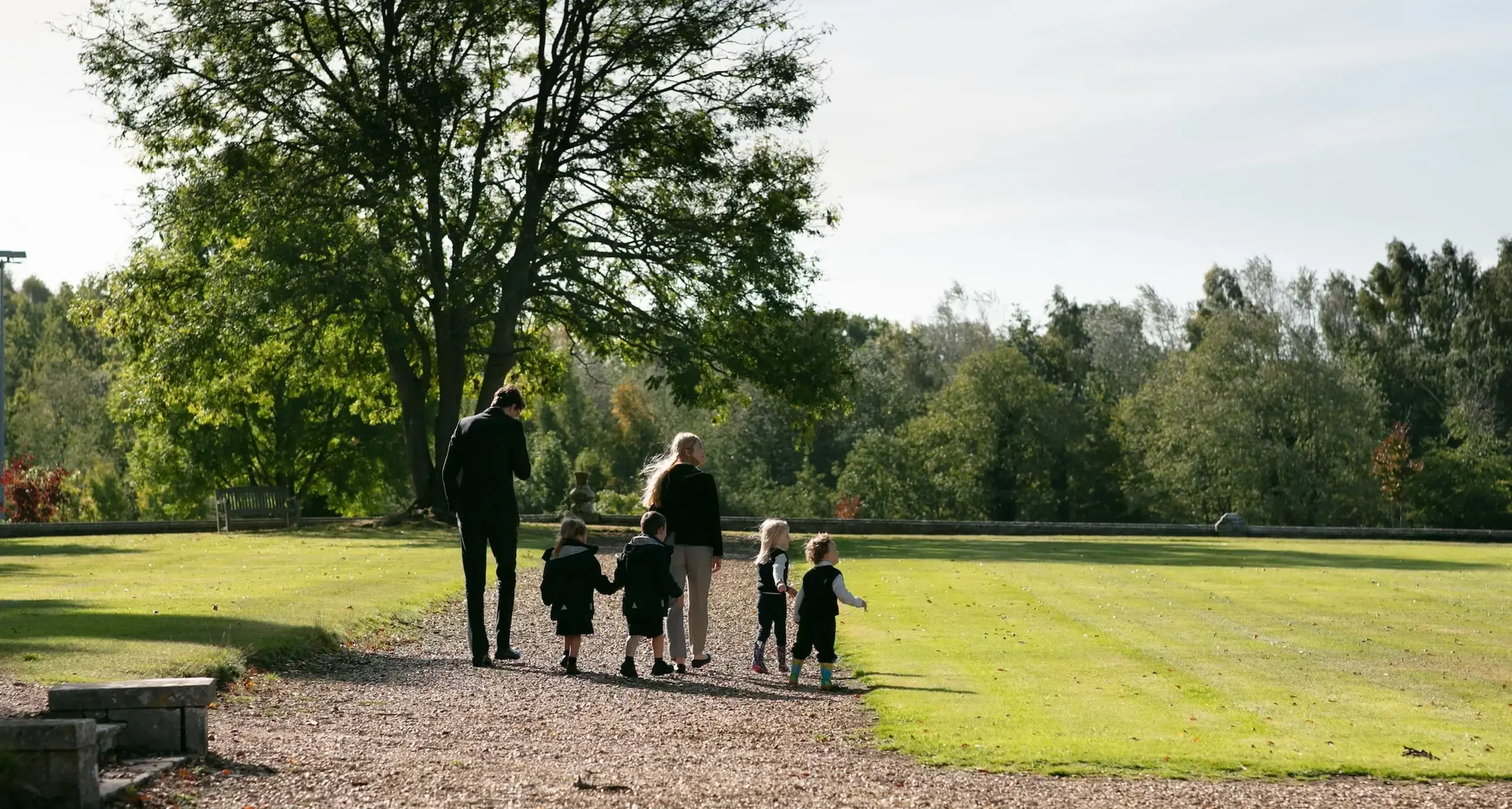 Family walking across Embley grounds