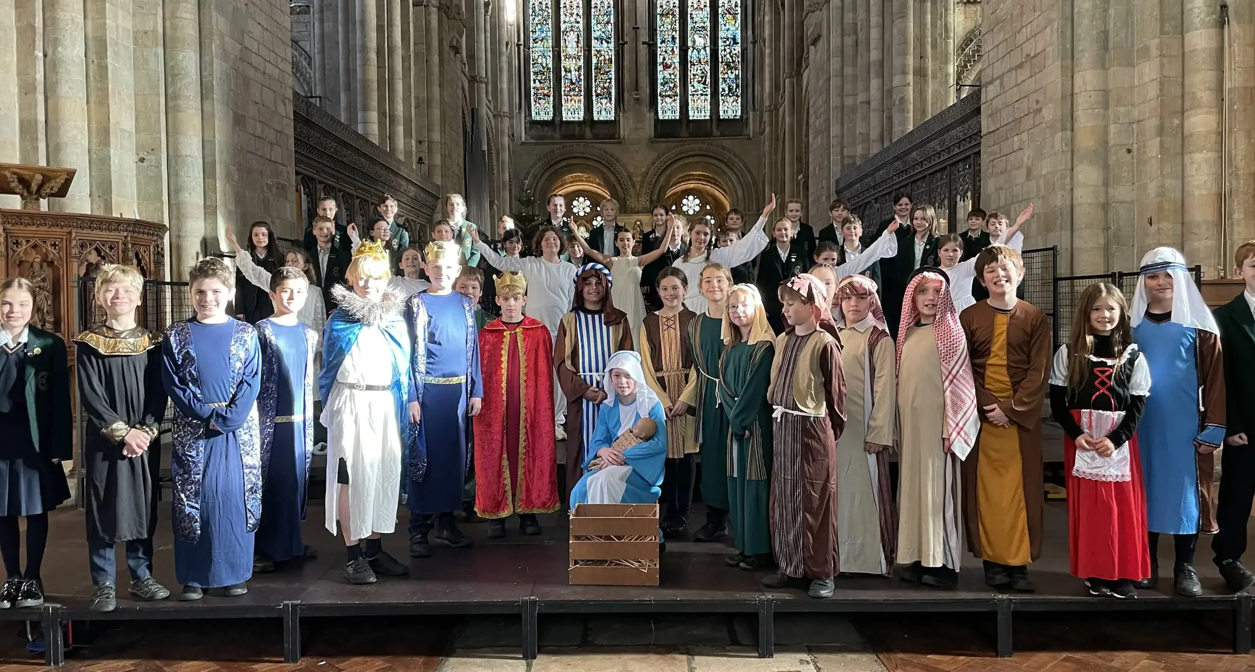 Students in nativity costume gathered to pose for the camera in the chapel